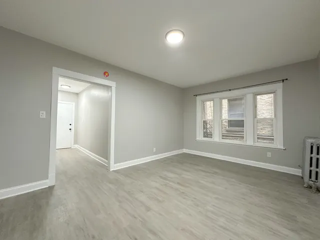 a large kitchen with stainless steel appliances granite countertop a stove a sink dishwasher and a refrigerator with wooden floor