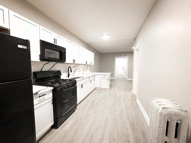a kitchen with a sink and a stove top oven