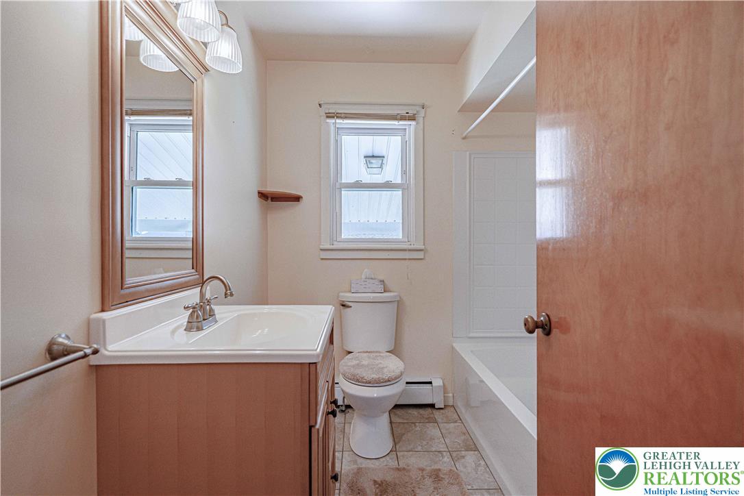 1115 Chestnut Street Coplay, PA 18037 - Photo 11 of 32 a bathroom with a sink a toilet and mirror