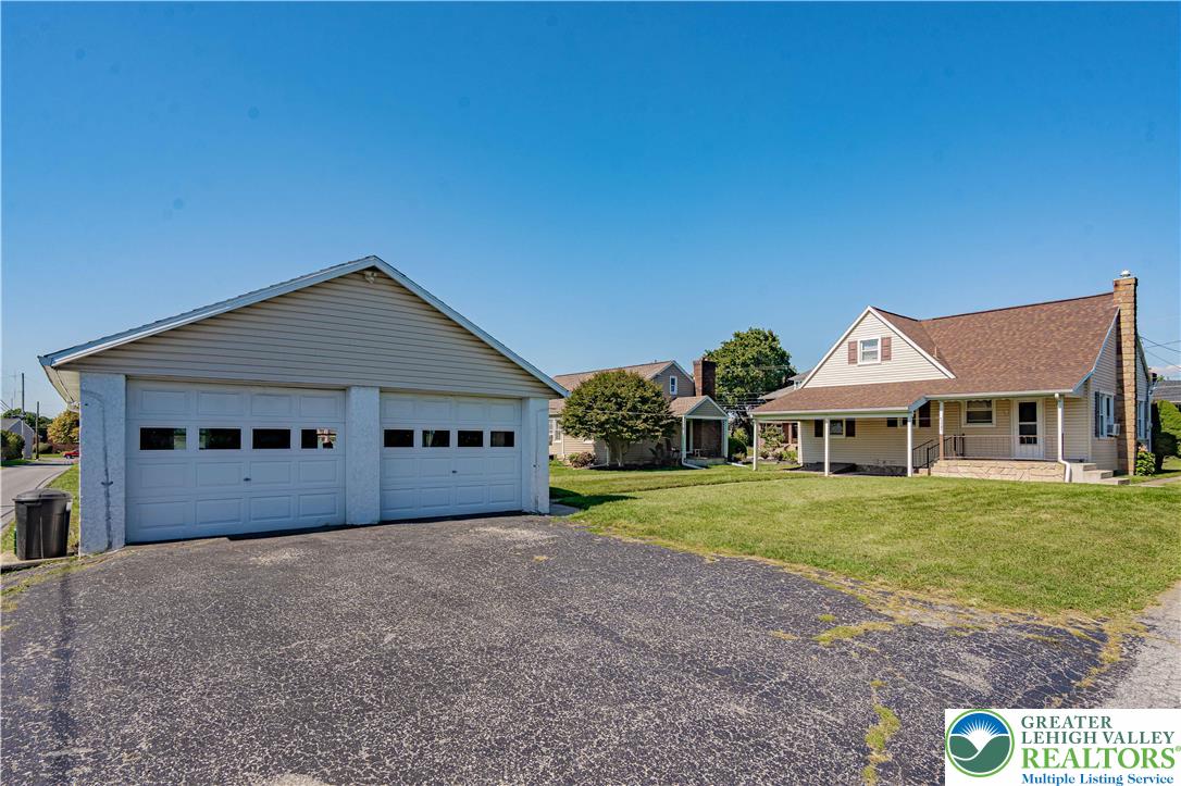 1115 Chestnut Street Coplay, PA 18037 - Photo 31 of 32 a front view of a house with a yard and garage