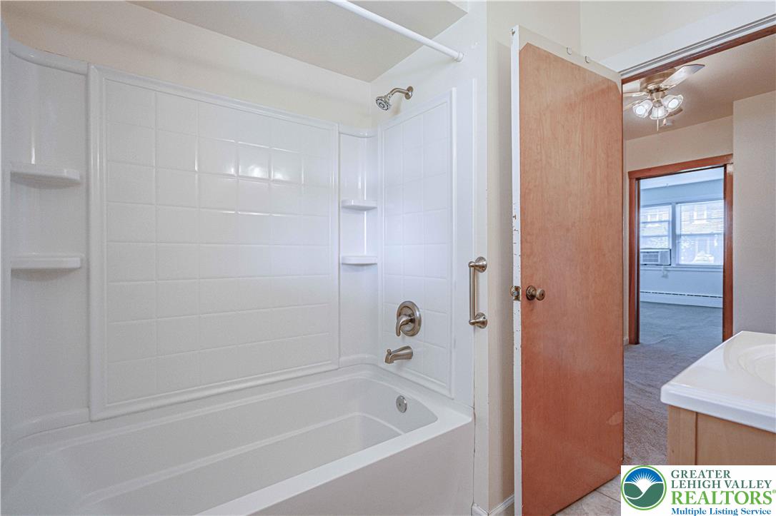 1115 Chestnut Street Coplay, PA 18037 - Photo 10 of 32 a white bath tub sitting next to a shower