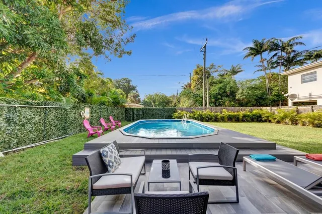 a view of a backyard with sitting area