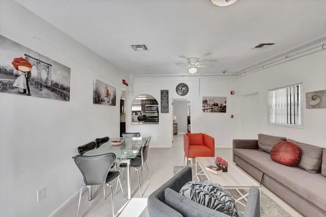 a living room with furniture fireplace and flat screen tv
