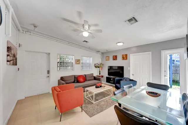 a living room with furniture a fireplace and a flat screen tv