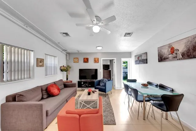 a kitchen with granite countertop a refrigerator stove and microwave