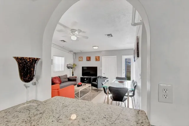 a kitchen with stainless steel appliances granite countertop a refrigerator stove sink and cabinets