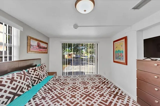 a bedroom with a bed and a night stand