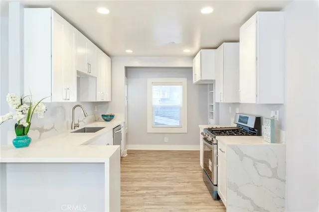 a view of a room with wooden floor and windows