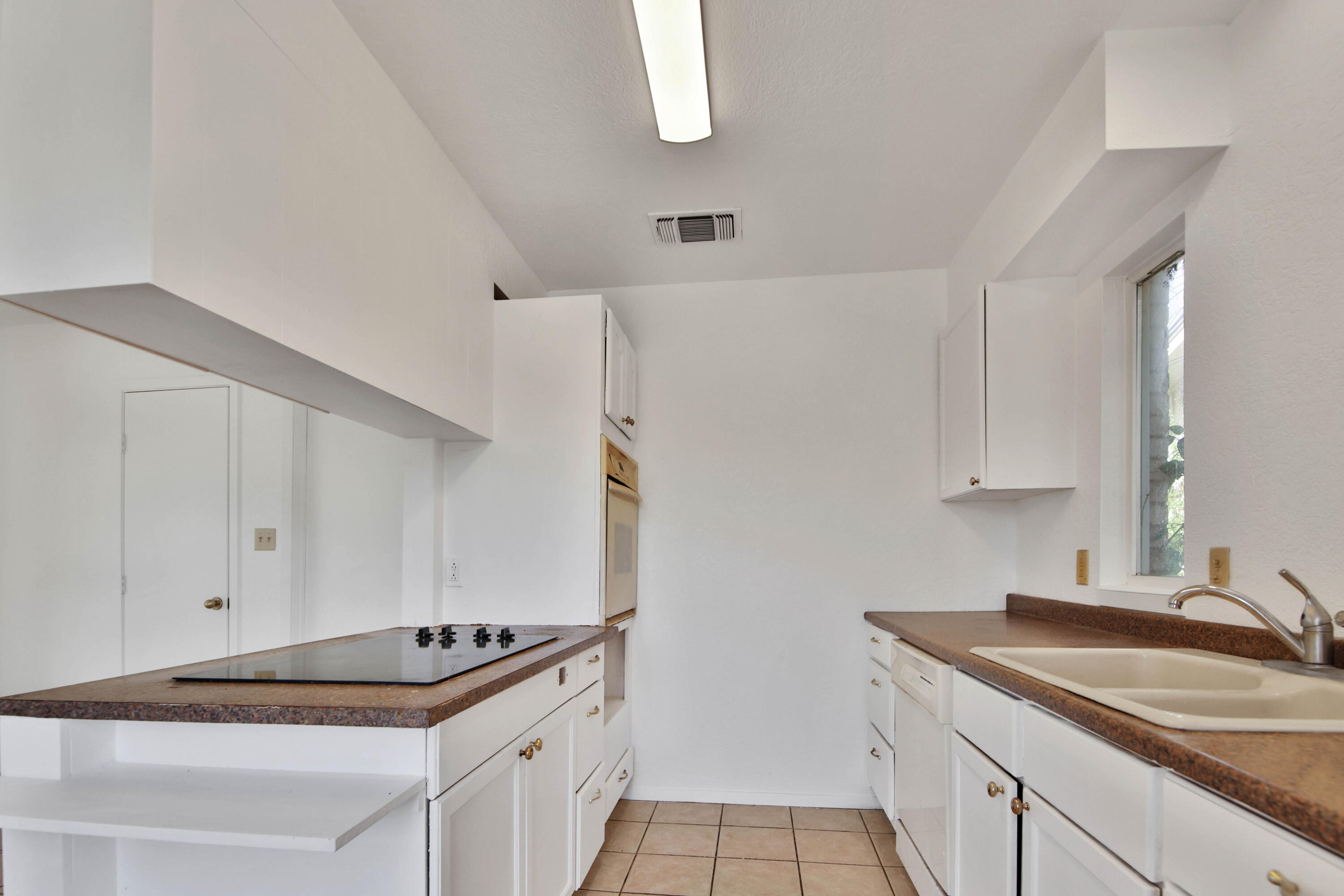 4913 56th Street Lubbock, TX 79414 - Photo 14 of 32 a kitchen with a sink and cabinets