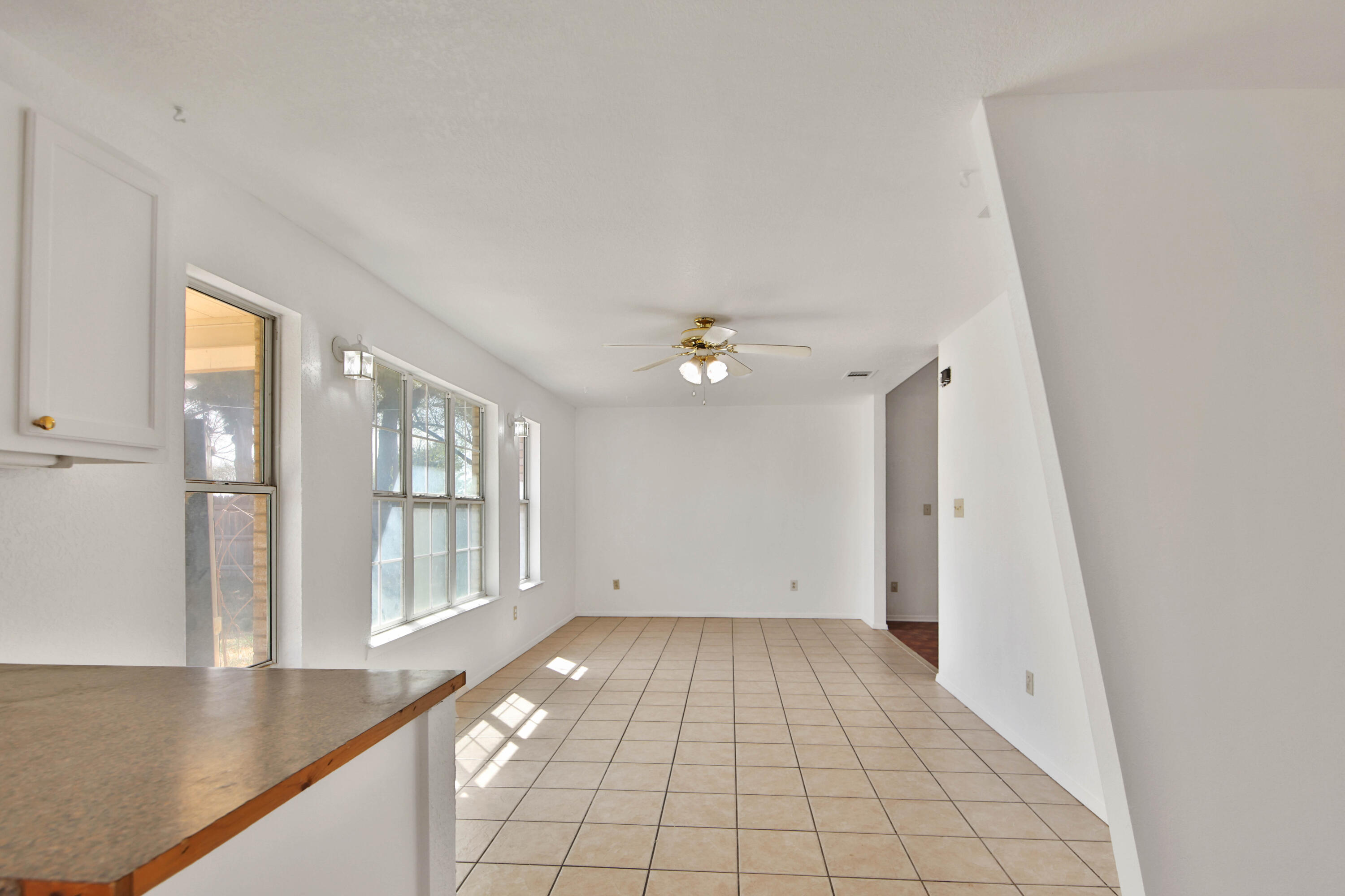 4913 56th Street Lubbock, TX 79414 - Photo 16 of 32 wooden floor in an empty room with a window