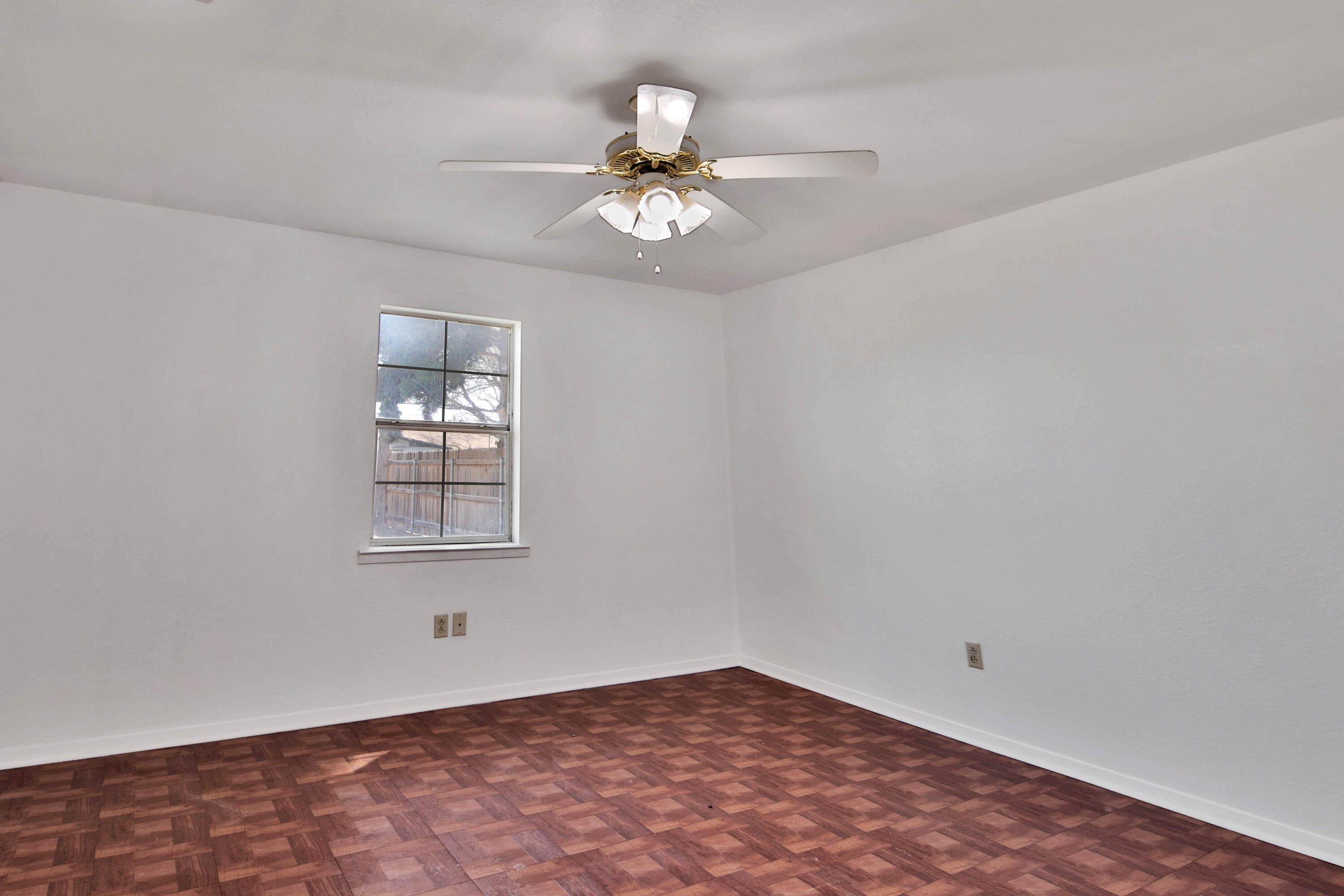 4913 56th Street Lubbock, TX 79414 - Photo 18 of 32 wooden floor in an empty room with a window