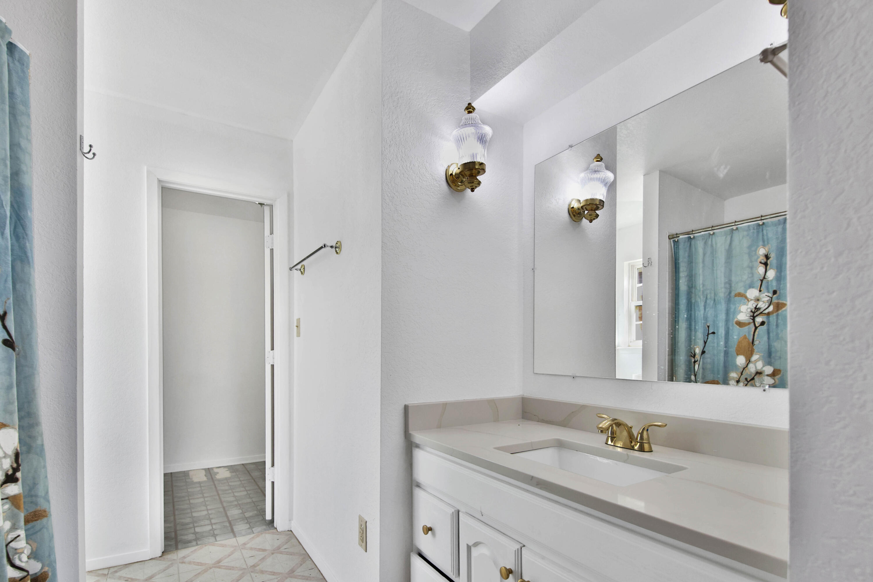 4913 56th Street Lubbock, TX 79414 - Photo 21 of 32 a bathroom with a sink and a mirror