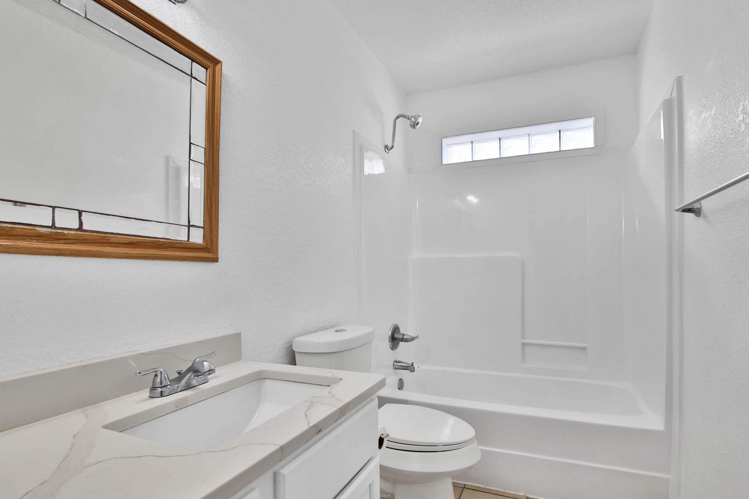 4913 56th Street Lubbock, TX 79414 - Photo 29 of 32 a bathroom with a bathtub shower sink vanity and toilet