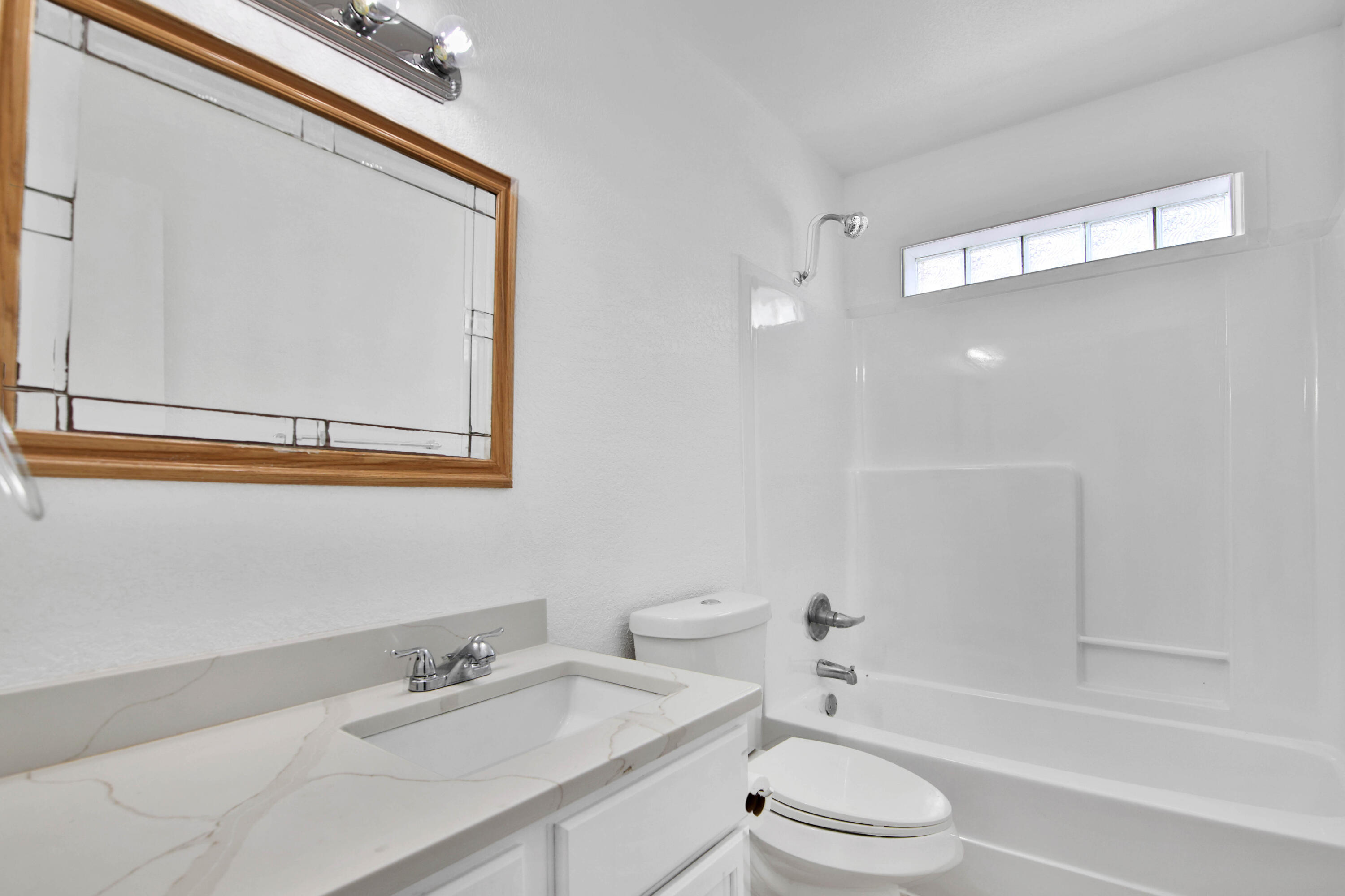 4913 56th Street Lubbock, TX 79414 - Photo 30 of 32 a bathroom with a sink a toilet and shower