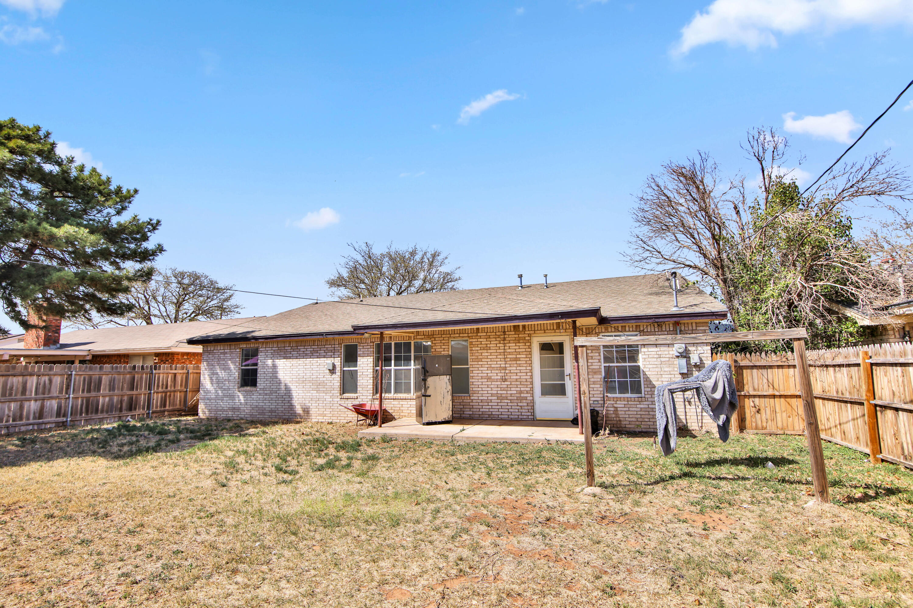 4913 56th Street Lubbock, TX 79414 - Photo 32 of 32 a view of a yard with a house and a tree