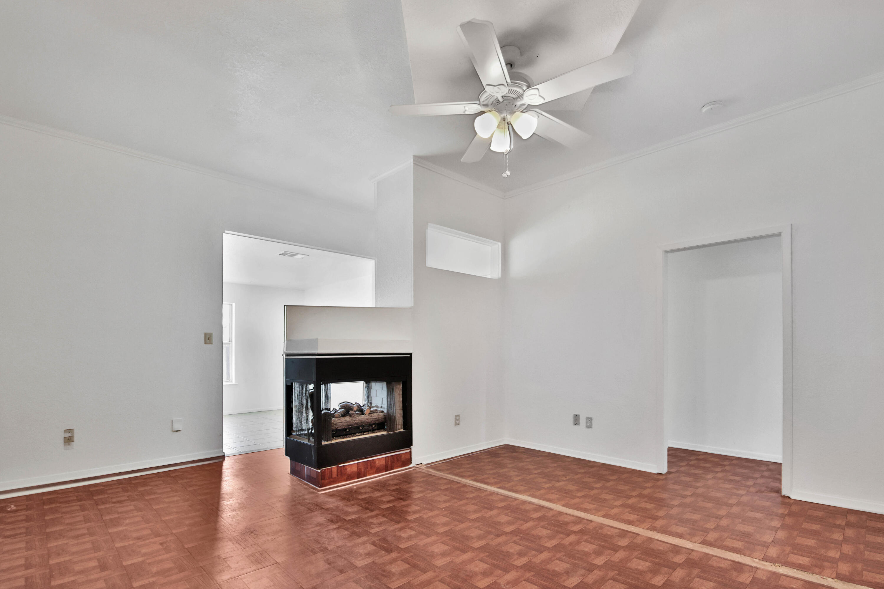 4913 56th Street Lubbock, TX 79414 - Photo 5 of 32 a view of an empty room with wooden floor fireplace and a window