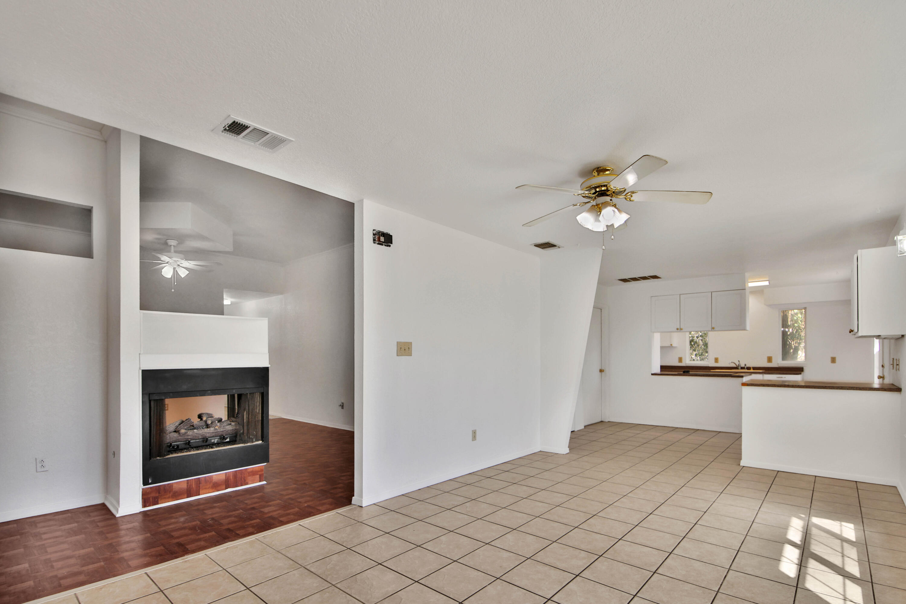 4913 56th Street Lubbock, TX 79414 - Photo 9 of 32 a view of a kitchen with a sink a refrigerator and a fireplace
