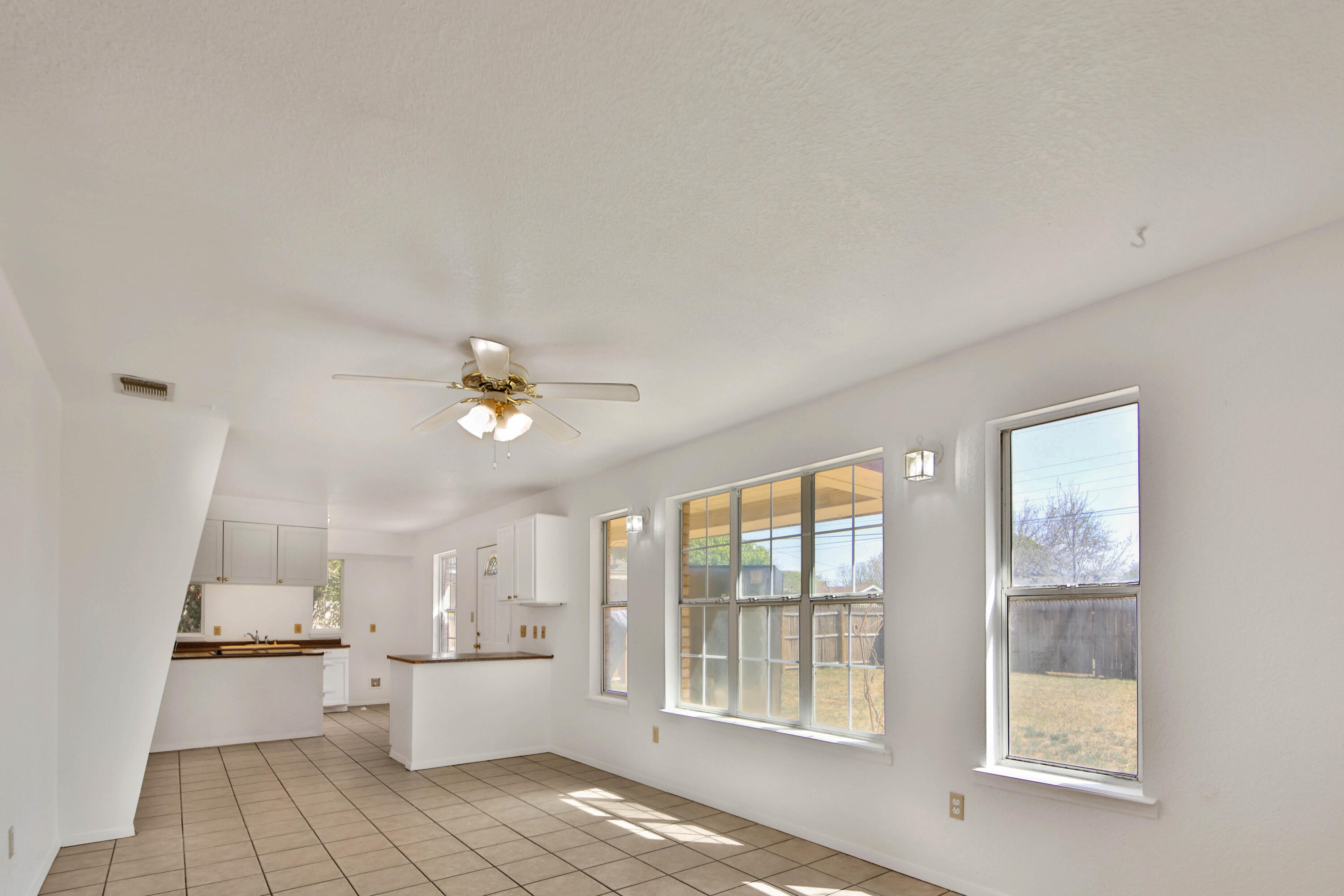 4913 56th Street Lubbock, TX 79414 - Photo 10 of 32 a open kitchen with white cabinets and white appliances