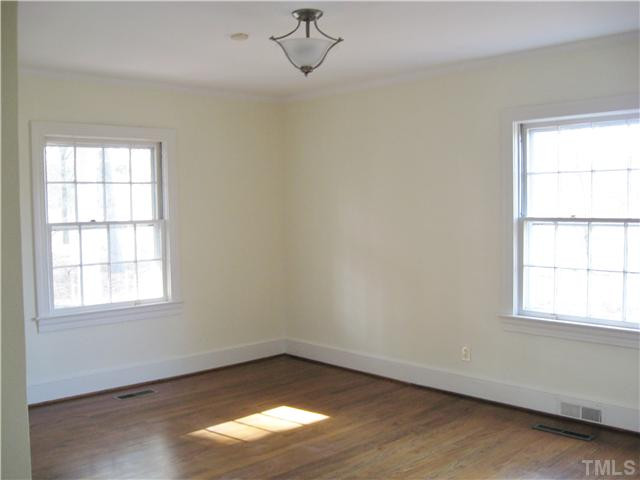 232-c C Cc Routh Road Bear Creek, NC 27207 - Photo 13 of 24 an empty room with wooden floor windows and fan