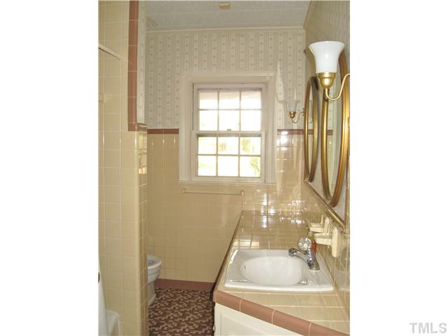 232-c C Cc Routh Road Bear Creek, NC 27207 - Photo 14 of 24 a bath tub sitting in a bathroom next to a window