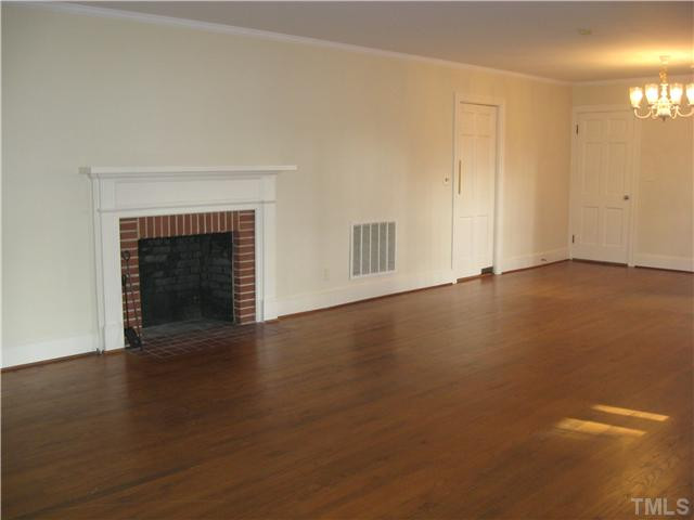 232-c C Cc Routh Road Bear Creek, NC 27207 - Photo 4 of 24 a view of an empty room with wooden floor and a fireplace