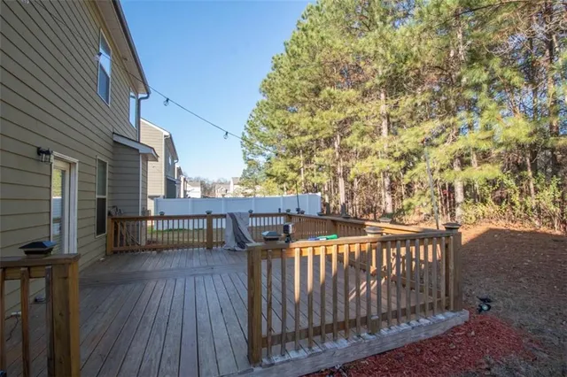 a view of a balcony with wooden floor and fence