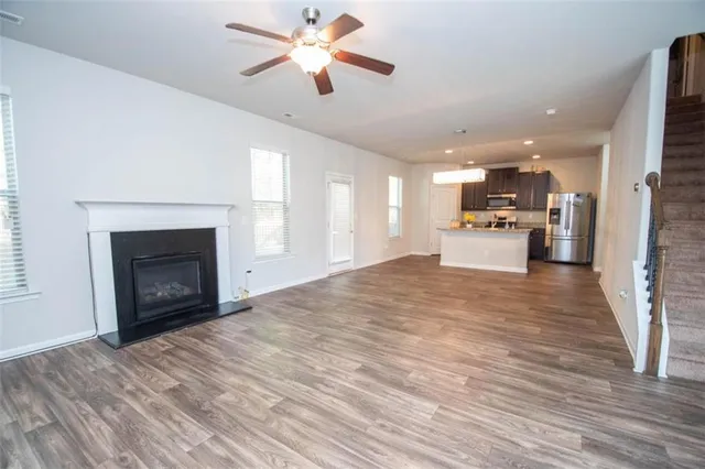 a view of a kitchen with a fireplace a sink and a living room