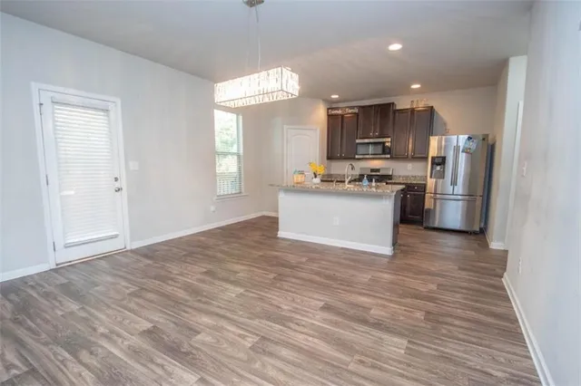 a view of a kitchen with a sink wooden floor and a window