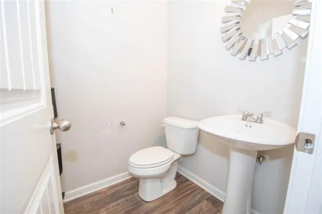 a white toilet sitting next to a bathroom sink