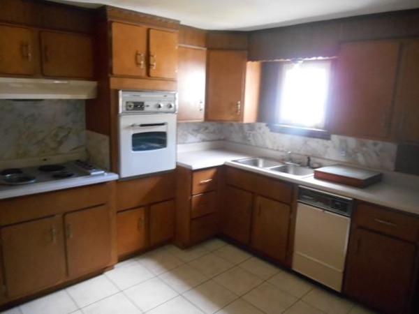 100 Cuff Avenue Springfield, MA 01104 - Photo 4 of 14 a kitchen with cabinets a sink and a stove