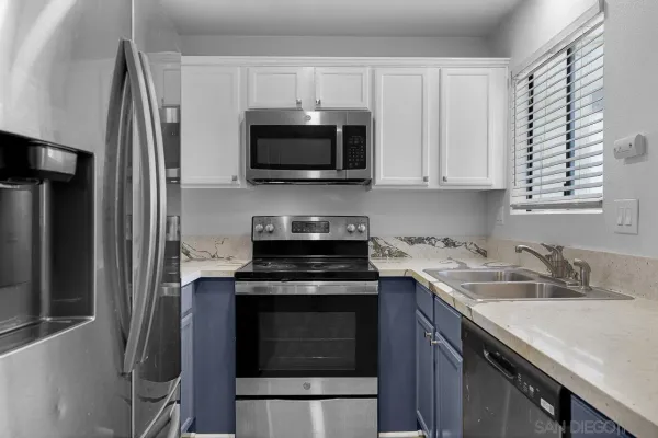 a kitchen with a sink stove and microwave