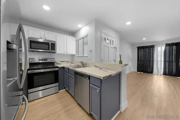 a kitchen with a sink and steel appliances