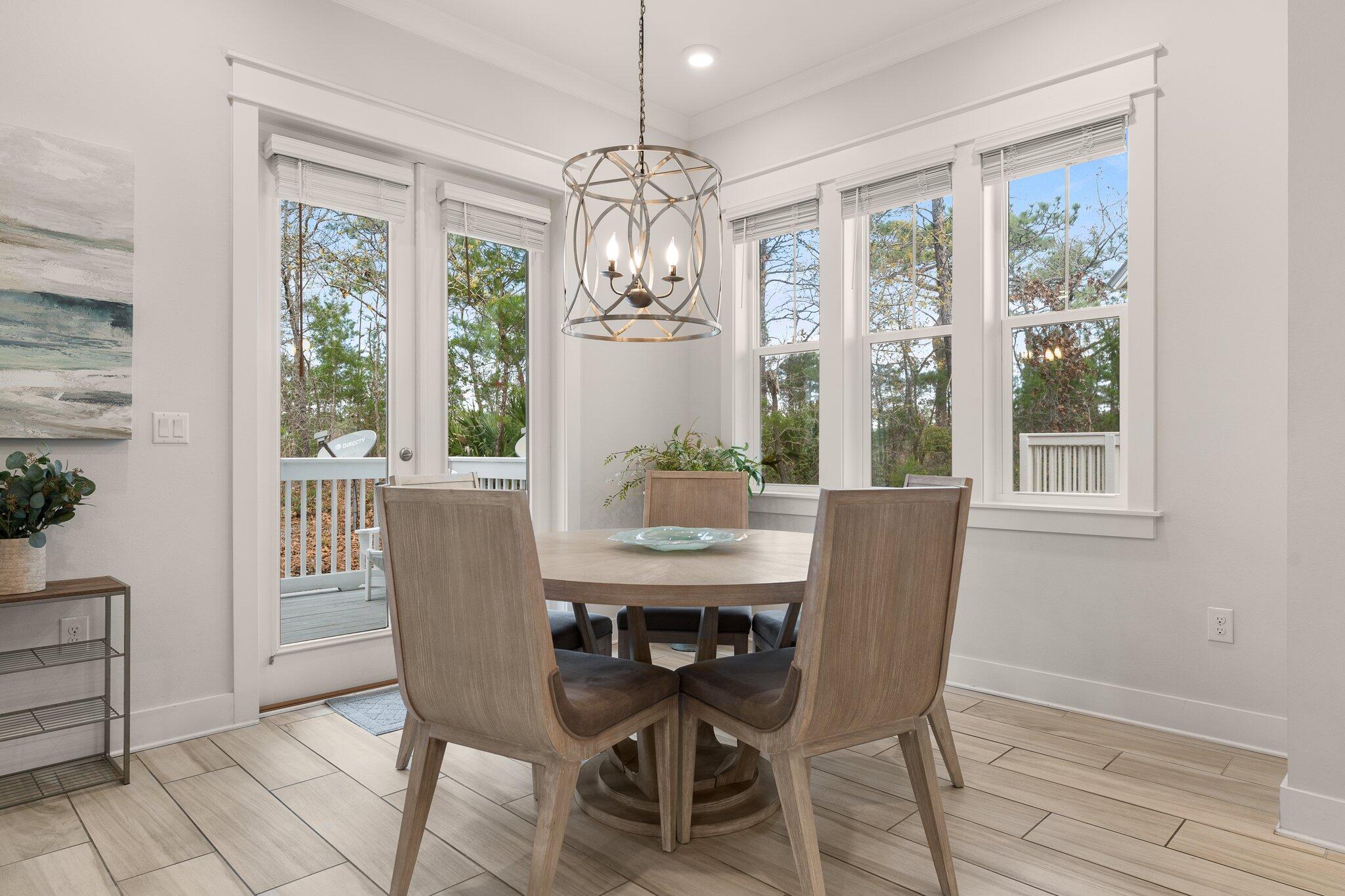 117 Pine Lands Loop Inlet Beach, FL 32461 - Photo 11 of 48 a view of a dining room with furniture large windows and wooden floor