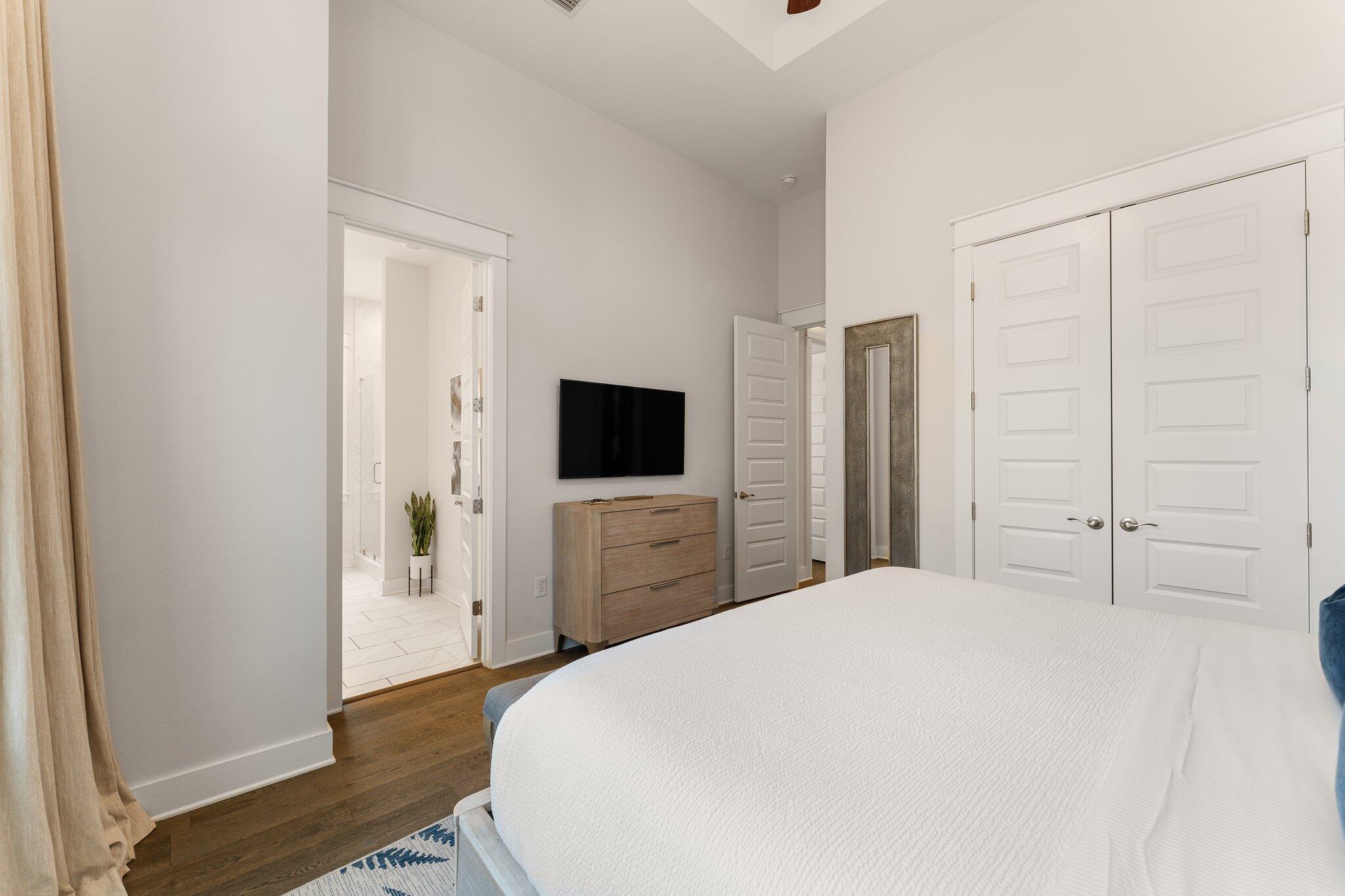 117 Pine Lands Loop Inlet Beach, FL 32461 - Photo 19 of 48 a large bedroom with a bed and a flat screen tv