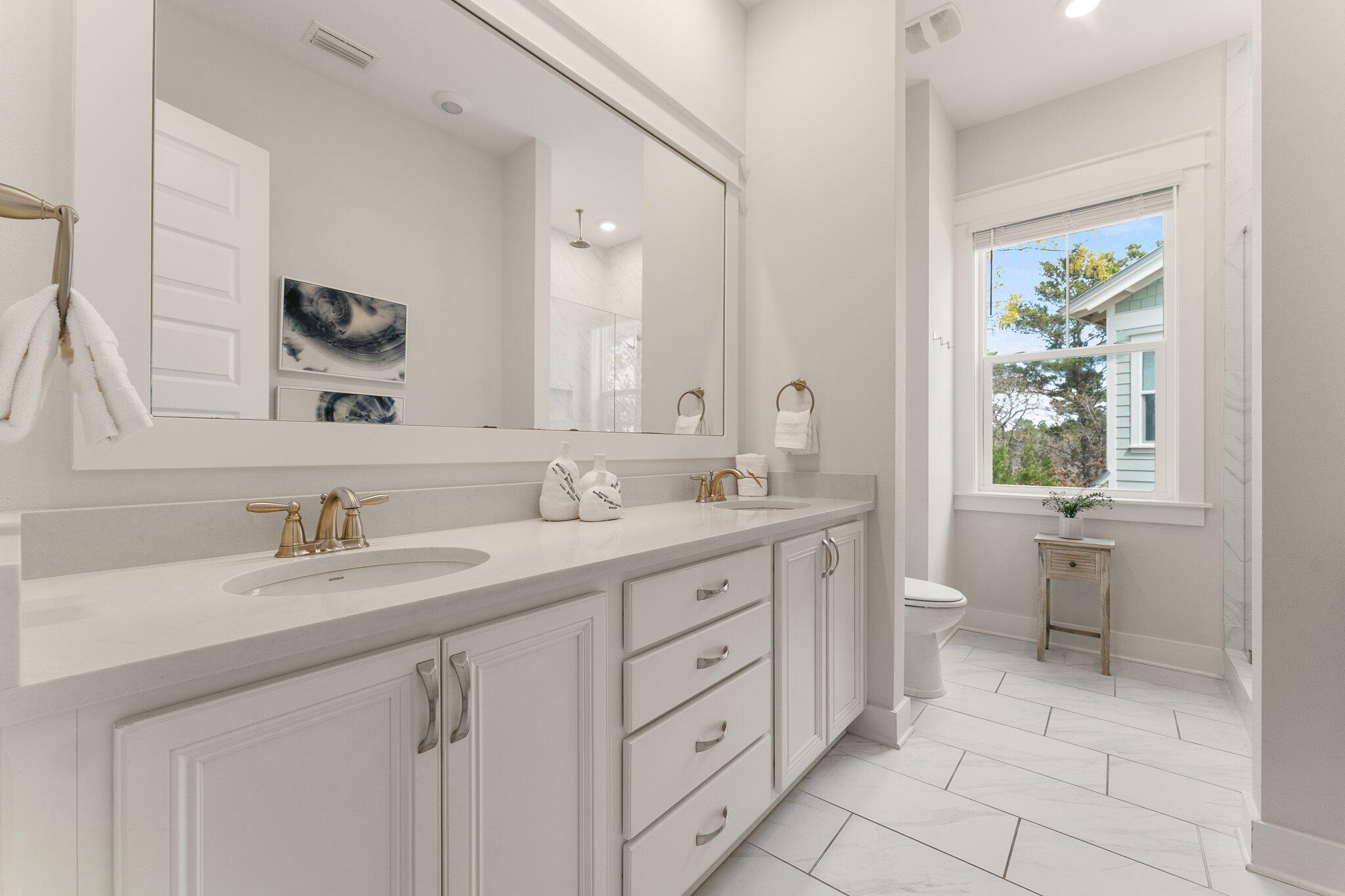117 Pine Lands Loop Inlet Beach, FL 32461 - Photo 20 of 48 a bathroom with a double vanity sink a toilet and a mirror