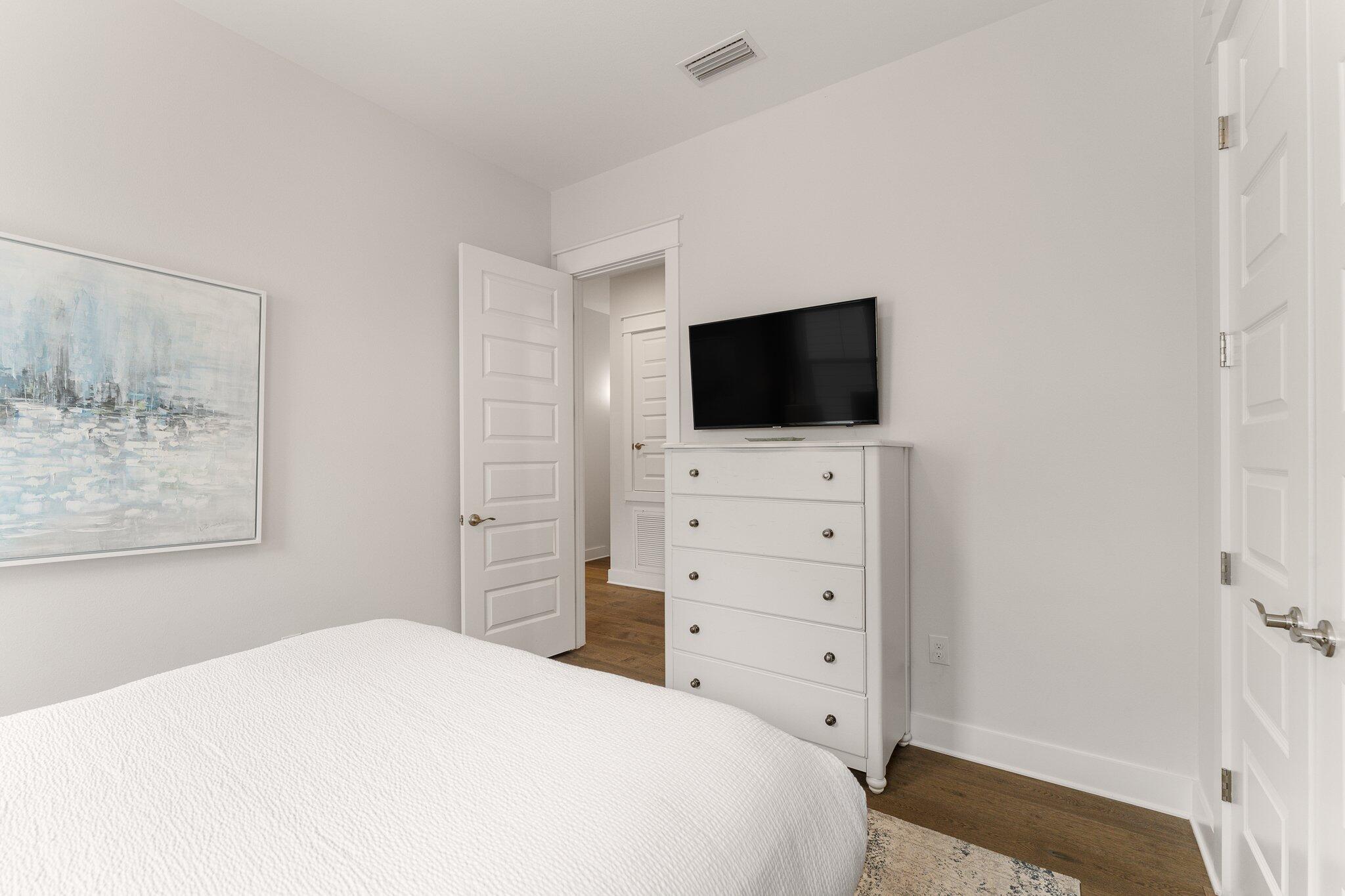 117 Pine Lands Loop Inlet Beach, FL 32461 - Photo 23 of 48 a bedroom with a bed and a flat screen tv