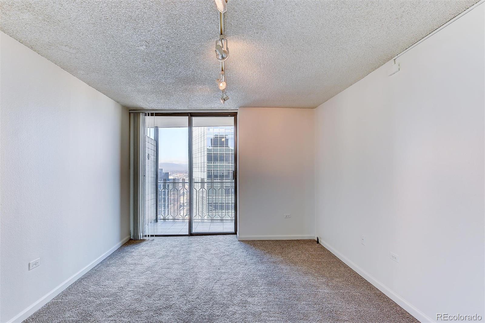 1020 15th Street, Unit 37E Denver, CO 80202 - Photo 15 of 48 an empty room with chandelier fan and windows