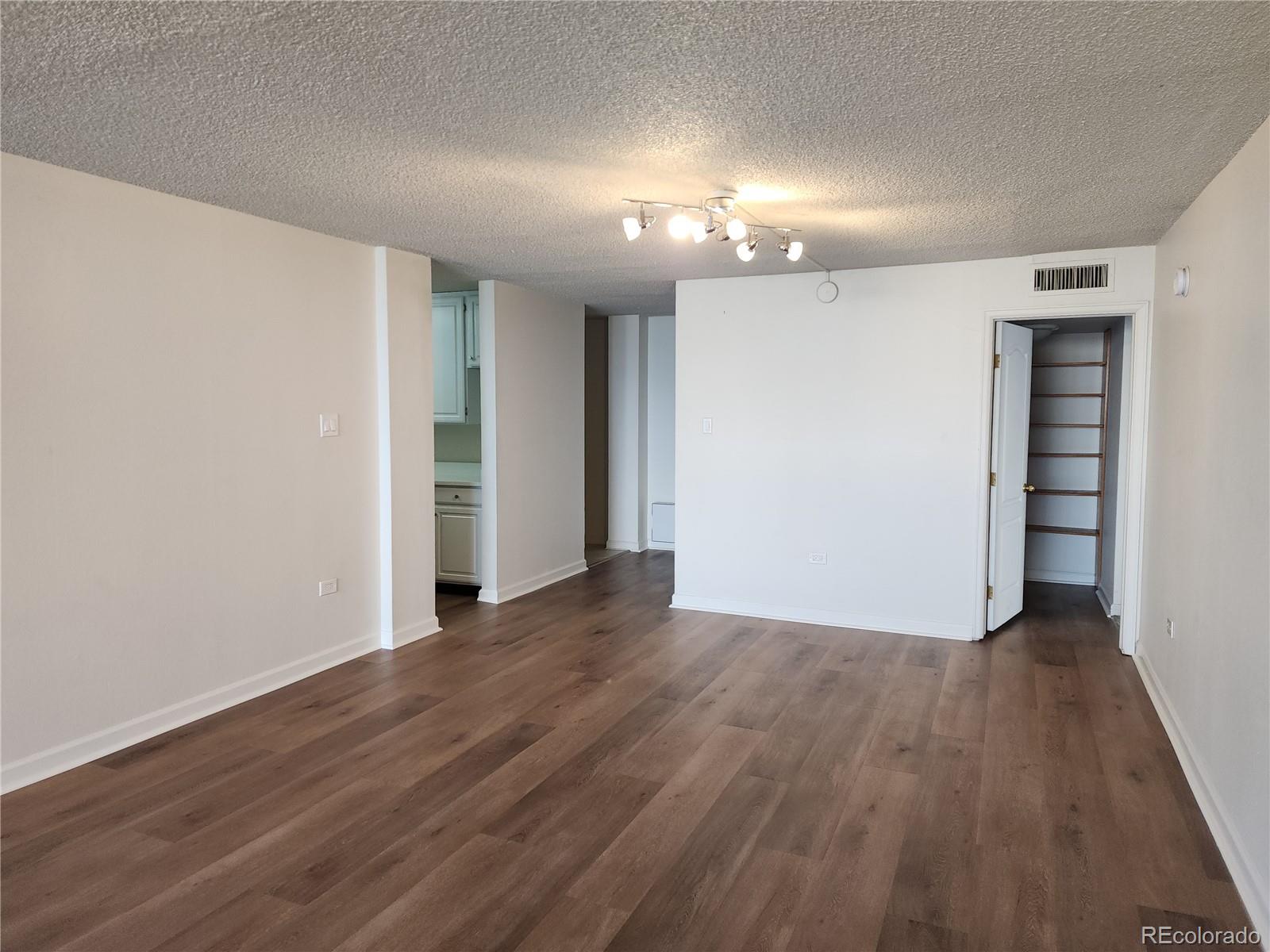 1020 15th Street, Unit 37E Denver, CO 80202 - Photo 19 of 48 a view of an empty room with wooden floor