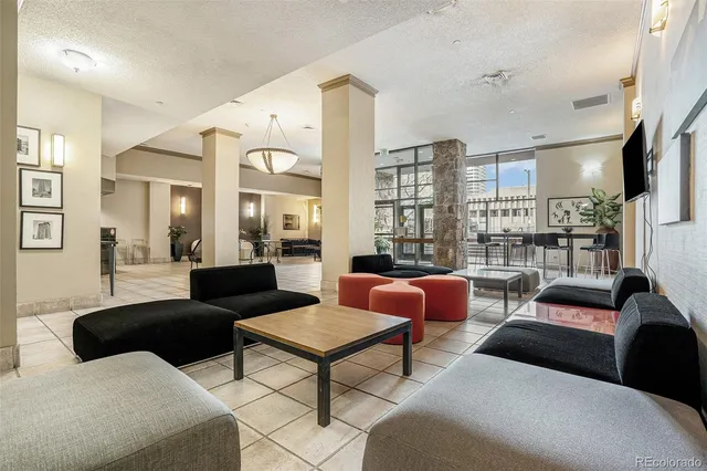 a living room with furniture a rug and a large window