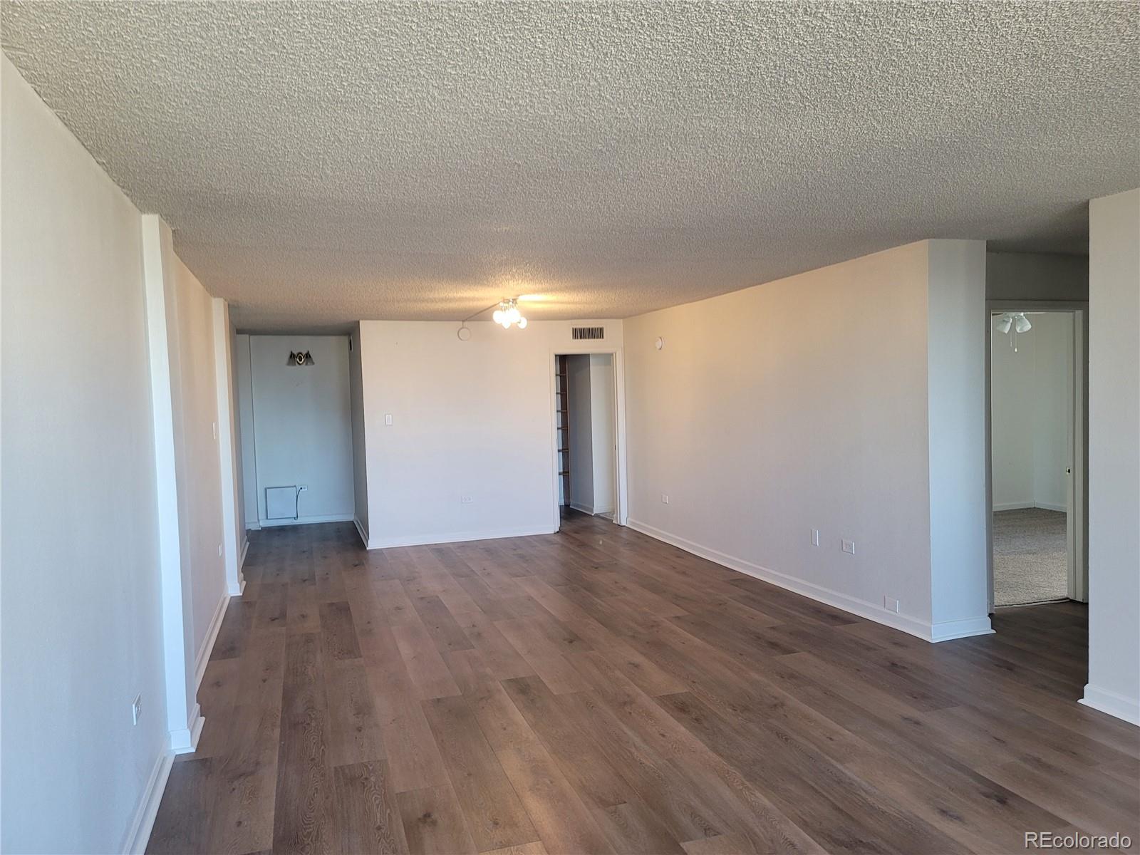 1020 15th Street, Unit 37E Denver, CO 80202 - Photo 4 of 48 a view of a big room with wooden floor and windows