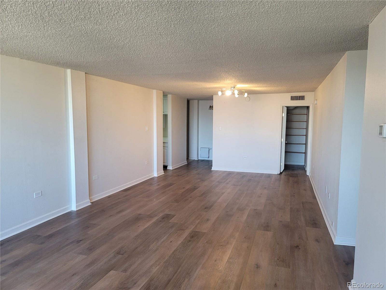 1020 15th Street, Unit 37E Denver, CO 80202 - Photo 7 of 48 a view of a room with wooden floor and stairs
