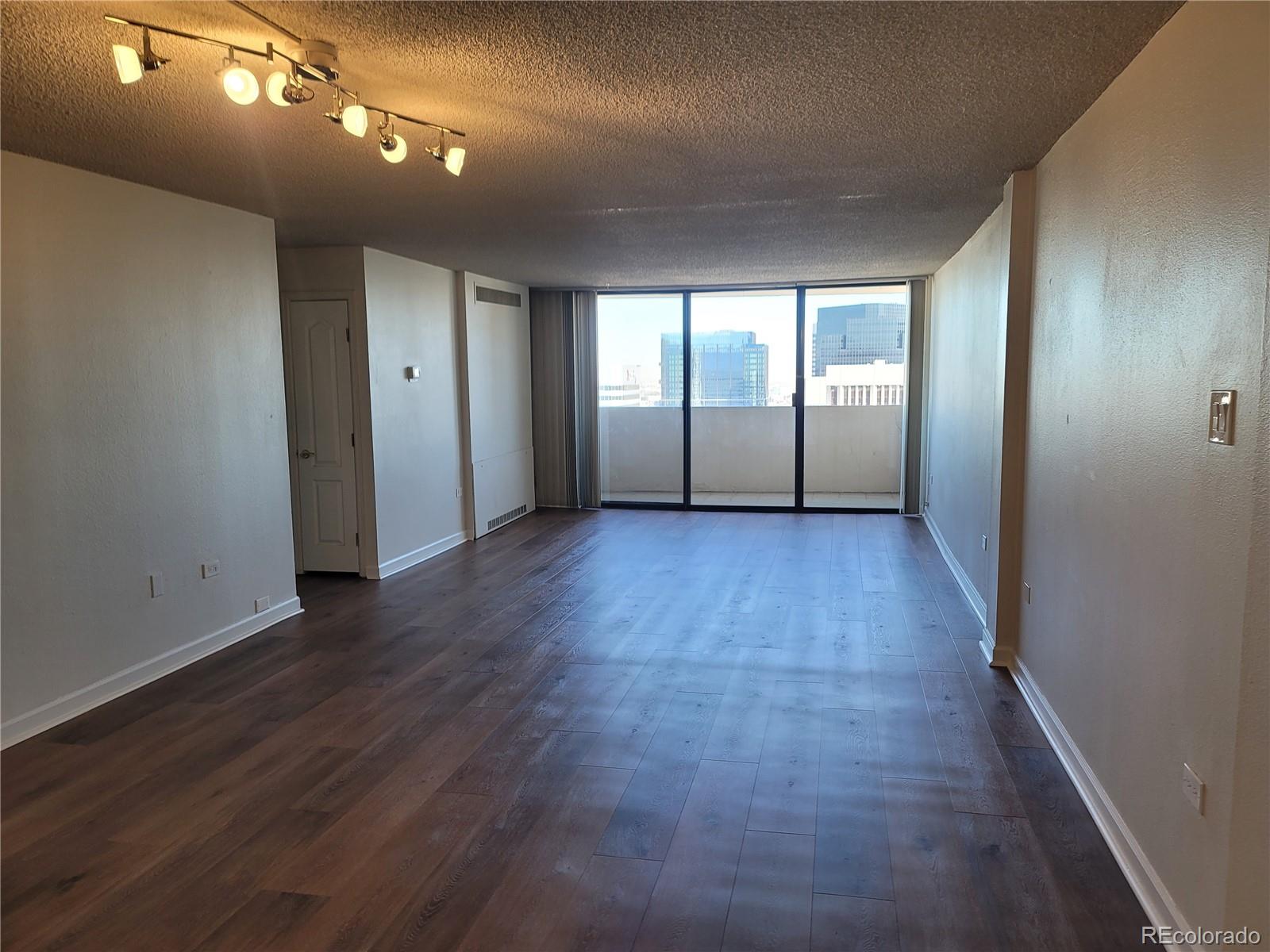 1020 15th Street, Unit 37E Denver, CO 80202 - Photo 8 of 48 an empty room with wooden floor and windows