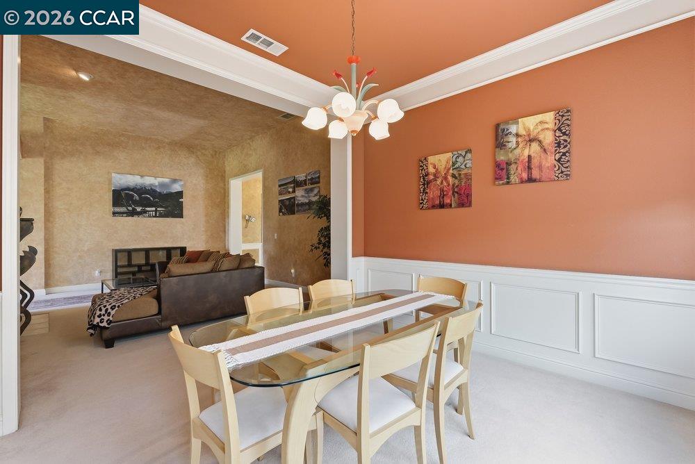 1009 Rolling Woods Way Concord, CA 94521 - Photo 21 of 69 a view of a dining room with furniture and a chandelier fan