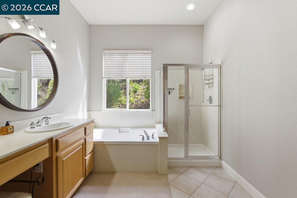 1009 Rolling Woods Way Concord, CA 94521 - Photo 30 of 69 a bathroom with a bathtub sink mirror and vanity