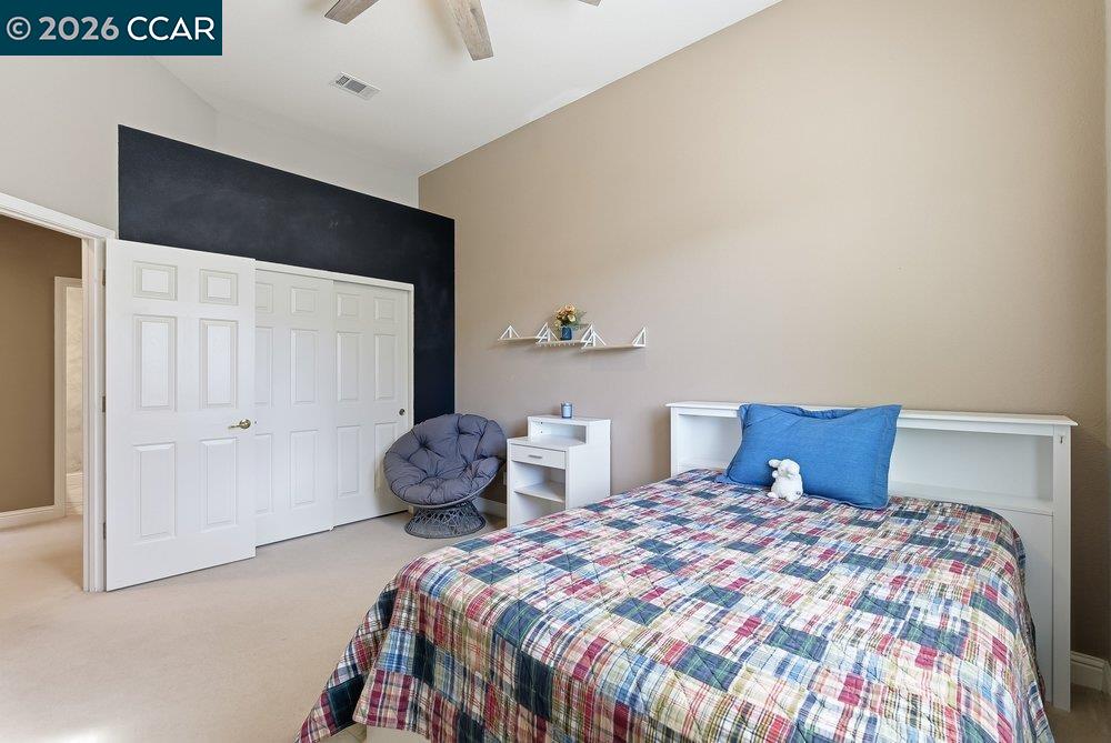 1009 Rolling Woods Way Concord, CA 94521 - Photo 33 of 69 a bedroom with a bed and a painting on the wall