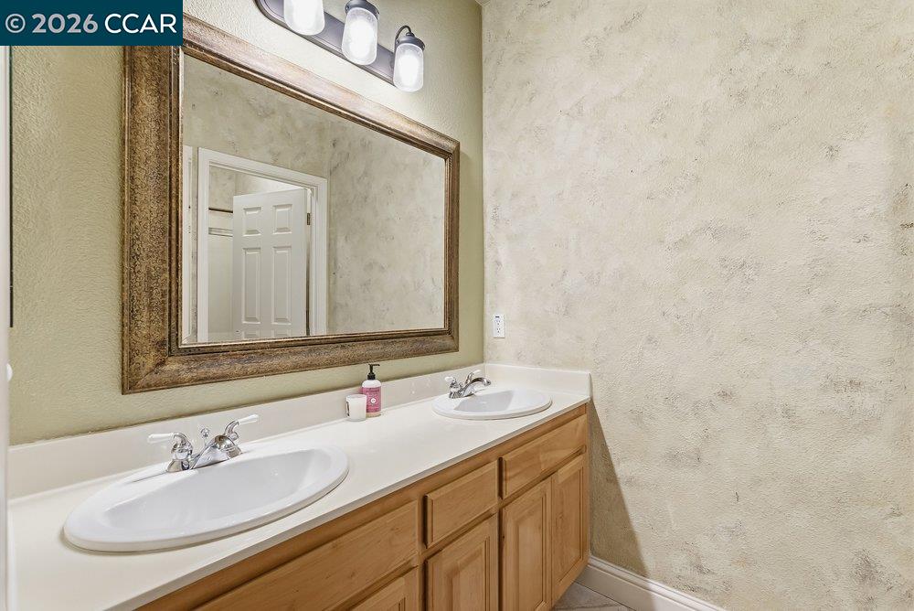 1009 Rolling Woods Way Concord, CA 94521 - Photo 37 of 69 a bathroom with a sink and a mirror
