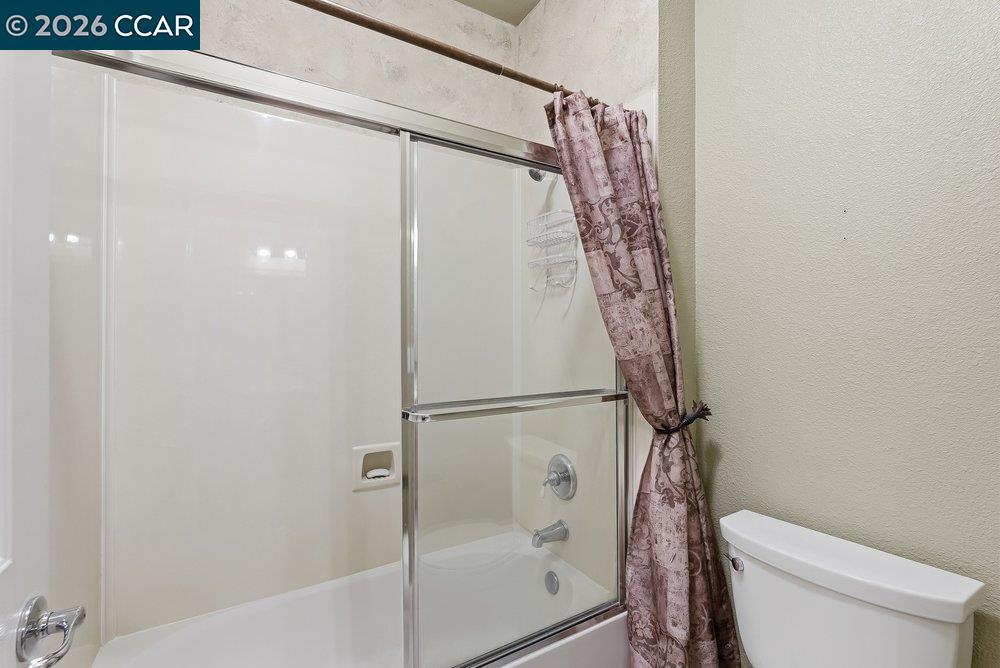 1009 Rolling Woods Way Concord, CA 94521 - Photo 38 of 69 a bathroom with a shower and toilet