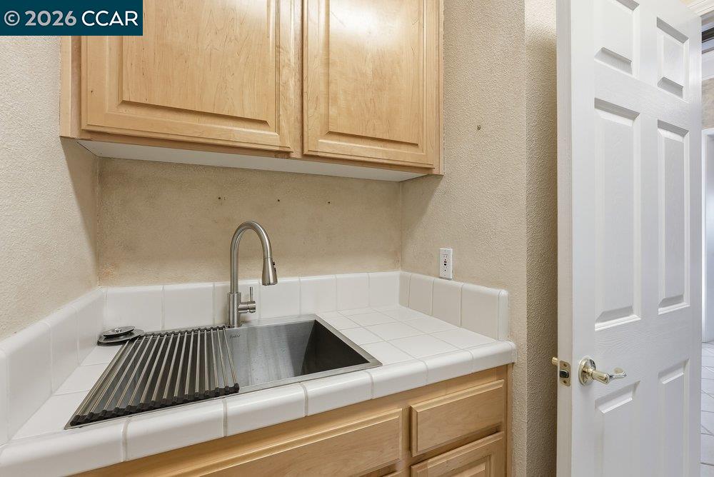 1009 Rolling Woods Way Concord, CA 94521 - Photo 40 of 69 a view of a sink and dishwasher with wooden floor