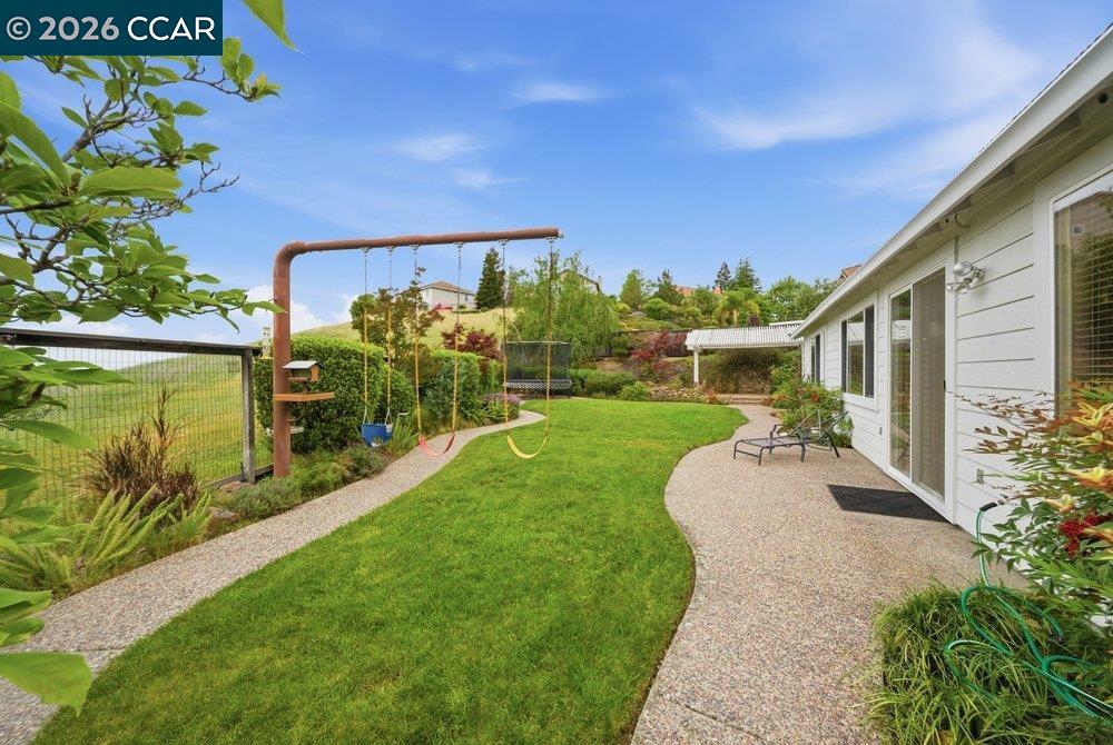 1009 Rolling Woods Way Concord, CA 94521 - Photo 49 of 69 a view of a garden with a building in the background
