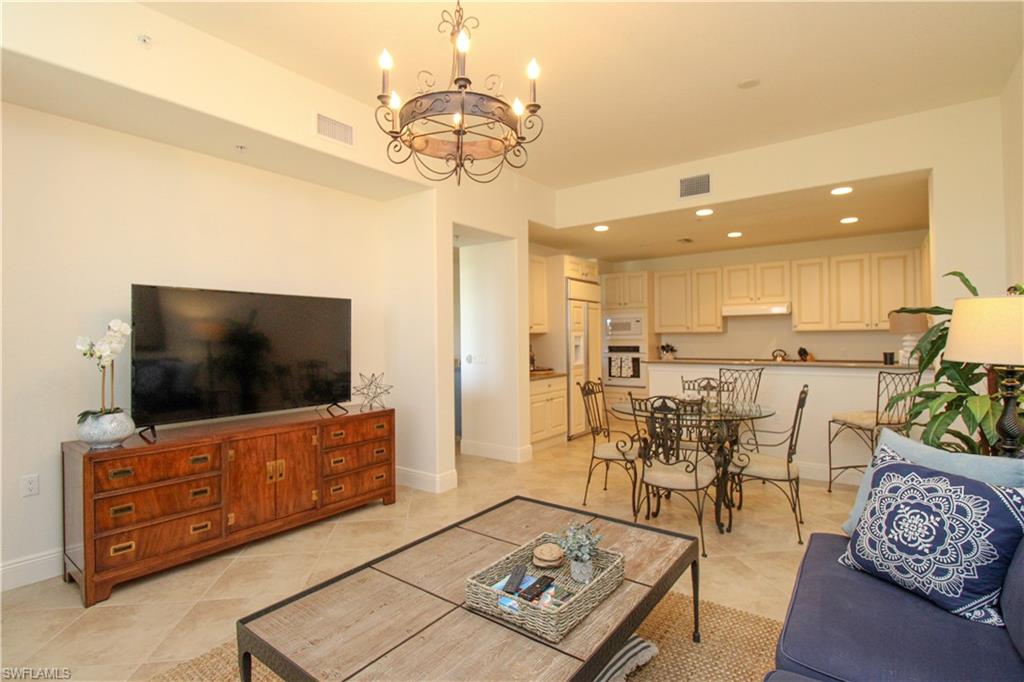 2713 Callista Court, Unit 103 Naples, FL 34114 - Photo 19 of 47 a living room with furniture and a flat screen tv